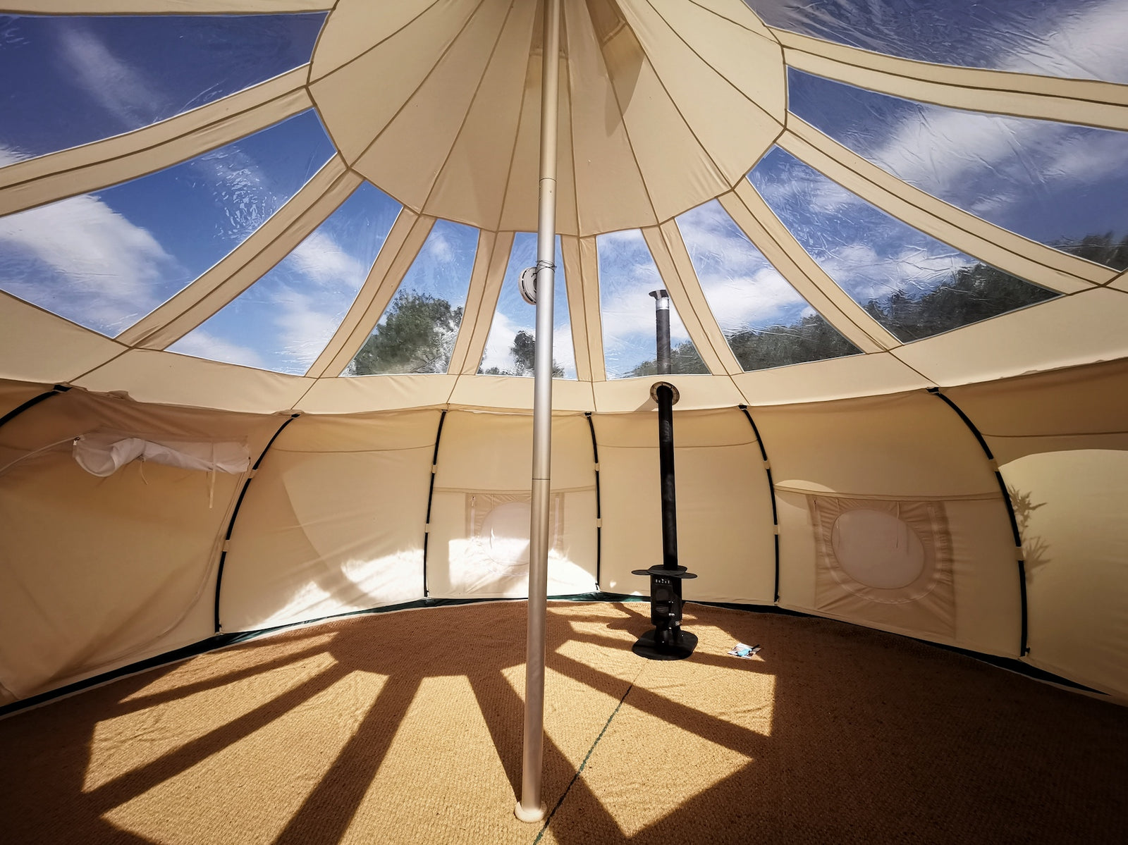 Woodburning Stoves For Tents. A Picture of woodburing stove set up inside a canvas Stargazer tent - Lotus Belle UK